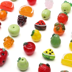 Macro display of colorful fruit-shaped glass beads for handmade jewelry DIY projects