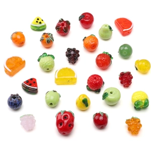 Assorted colorful glass fruit beads featuring strawberry apple and grape for DIY jewelry