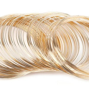 Stack of gold memory wire coils for DIY jewelry making with smooth metallic finish
