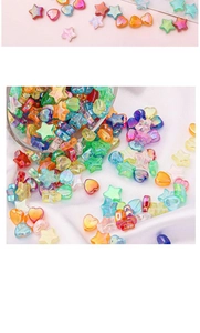 Macro shot of iridescent star and heart shaped acrylic beads for DIY jewelry making