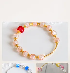 Detail of 14K gold plated curved tube beads with orange crackle quartz beads for jewelry