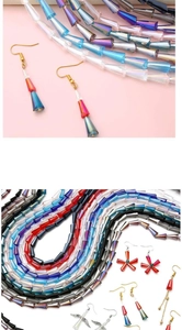 Macro view of colorful tapered crystal glass beads and handmade drop earrings with gold hooks