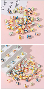 Close-up of ceramic DIY beads with colorful spiral stripes on white display steps