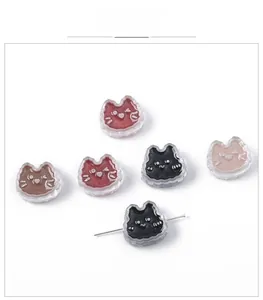 Detailed macro view of cute cat shaped acrylic beads with holes for DIY jewelry making