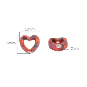 Detail of 13mm heart-shaped ceramic bead with colorful marble pattern and 2mm dual holes