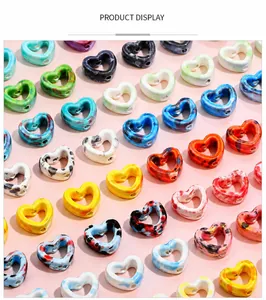 Macro shot of heart shaped ceramic beads with marble ink texture for DIY jewelry making
