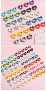 Macro shot of heart-shaped ceramic beads with artistic splatter ink marble texture