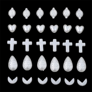 Assorted white faux pearl beads in heart, drop, and cross shapes for DIY jewelry making