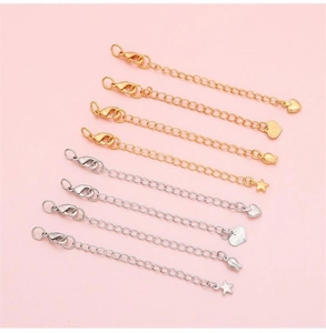 Detail of 14K gold and silver extender chains with lobster clasps and diverse charm pendants