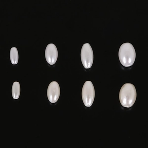 Macro shot of 8 oval ABS pearl beads with glossy white finish for DIY jewelry