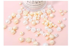 Macro detail of cream white acrylic rose and pearl beads for DIY jewelry making