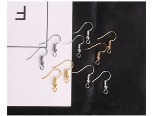 Macro shot of assorted gold and silver fish hook earrings with spring and ball detail