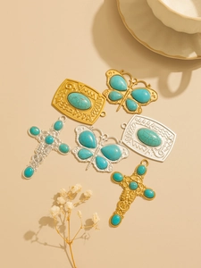 Detail of vintage Navajo style turquoise pendants featuring butterfly and cross designs