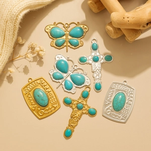 Vintage Navajo style turquoise pendants with butterfly and cross designs in gold and silver