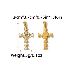 Macro detail of gold cross pendant with heart-shaped zircon inlay and polished back