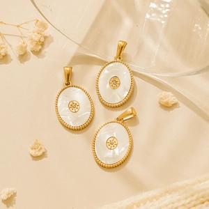 Detailed macro view of oval mother-of-pearl pendants with 18K gold-plated star charms