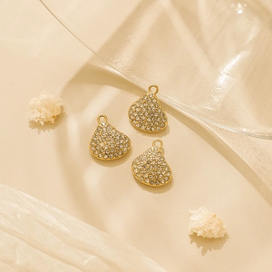 Three gold shell-shaped pendants with pave-set diamonds for DIY jewelry making