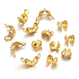 Detailed macro view of 12 gold plated stainless steel foldover crimp ends for DIY jewelry