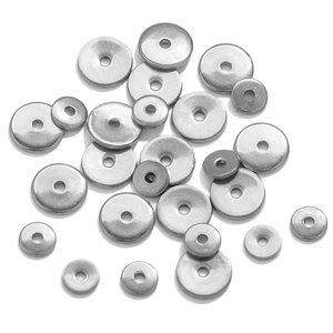 Flat lay of multiple sizes of polished silver 18K gold-plated spacer beads for DIY jewelry