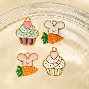 Detailed close-up of cute enamel bunny and cupcake charms for DIY jewelry making