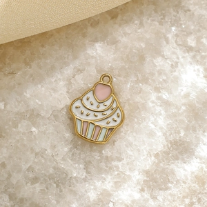 Macro view of a 304 stainless steel enamel cupcake pendant with pink heart detailing