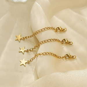 Détail de chaînes d'extension plaquées or 18k avec fermoirs homard et pendentifs en étoile