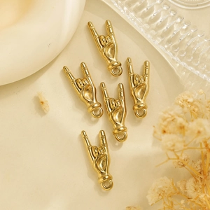 Close-up of golden rock-on hand gesture pendants with rings for jewelry making