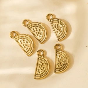 Detailed view of five gold watermelon slice pendants in polished stainless steel for DIY