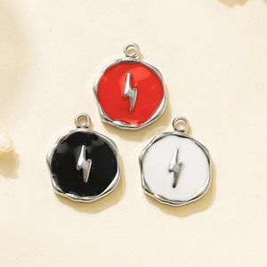 Macro detail of 304 stainless steel pendants with enamel lightning bolt in red black and white