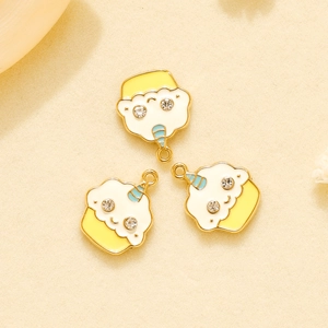 Macro detail of three unicorn cake charms with gold alloy edges and colorful enamel inlay