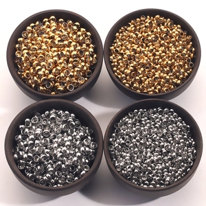 Polished gold and silver stainless steel spacer beads in ceramic bowls for DIY jewelry making