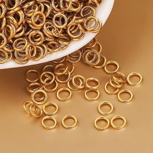 Bulk gold plated stainless steel jump rings for DIY jewelry making in a white ceramic bowl