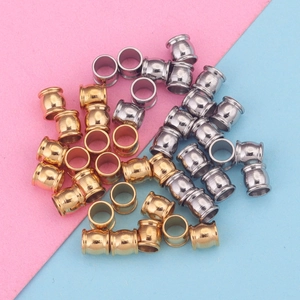 Macro detail of gold and silver plated stainless steel drum beads for DIY jewelry making