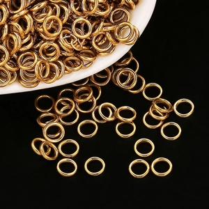 Bulk gold stainless steel jump rings for DIY jewelry making on white and black background