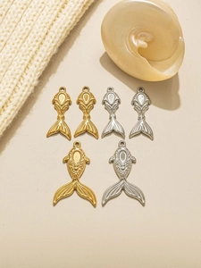 Detailed view of mermaid tail pendants in gold and silver for DIY jewelry crafts