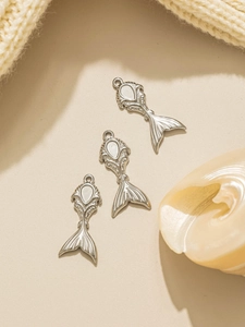 Detailed view of silver mermaid tail pendants for DIY jewelry and bag charms