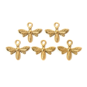 Detailed macro view of five shiny gold bee pendants with intricate wing textures for DIY jewelry