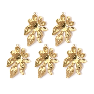 Detailed macro view of five irregular golden 304 stainless steel floral pendant charms