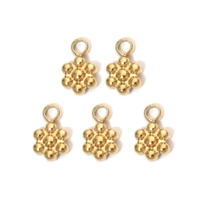Detailed view of five golden stainless steel flower pendants for DIY jewelry making