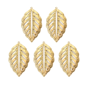 Detailed macro view of five golden hollow leaf pendants made of 304 stainless steel