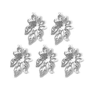 Detailed macro view of five 304 stainless steel hammered metal flower charms with hanging loops