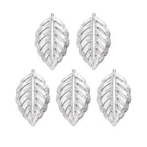 Detail macro view of five stainless steel leaf pendants with delicate texture and veins