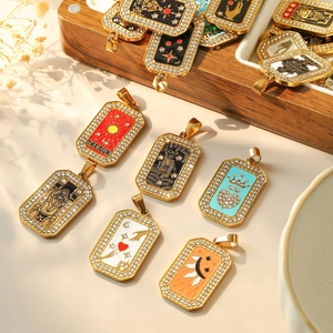 Gold tarot card pendants with inlaid rhinestones and colorful enamel on wooden box
