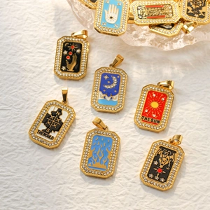 Detailed close-up of tarot card charms with crystals and colorful enamel in gold plating