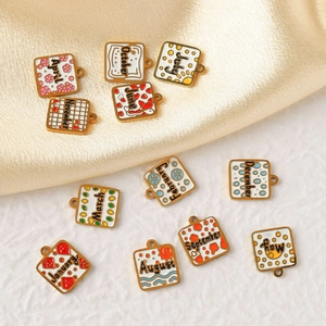 Set of 12 square gold-plated enamel pendants featuring monthly floral and seasonal themes