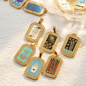 Detailed close-up of tarot card pendants with inlaid rhinestones and colorful enamel