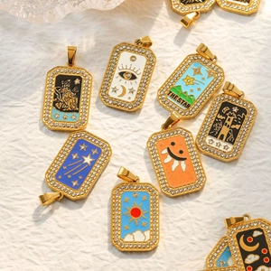Macro view of gold 304 stainless steel tarot charms with enamel art and crystals