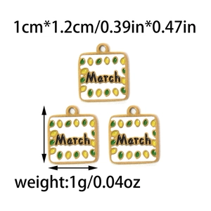 Detailed view of three March month enamel charms in 304 stainless steel and gold finish