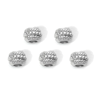 Detailed view of 5 textured stainless steel spacer beads with intricate spiral patterns
