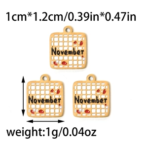 Detail of November birthday square charms with red enamel drip and hollow steel grid